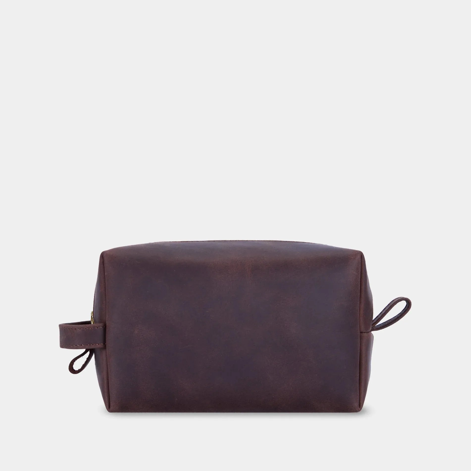 Вид згори на шкіряну косметичку Mirage з мʼякою формою та металевою блискавкою латунного кольору