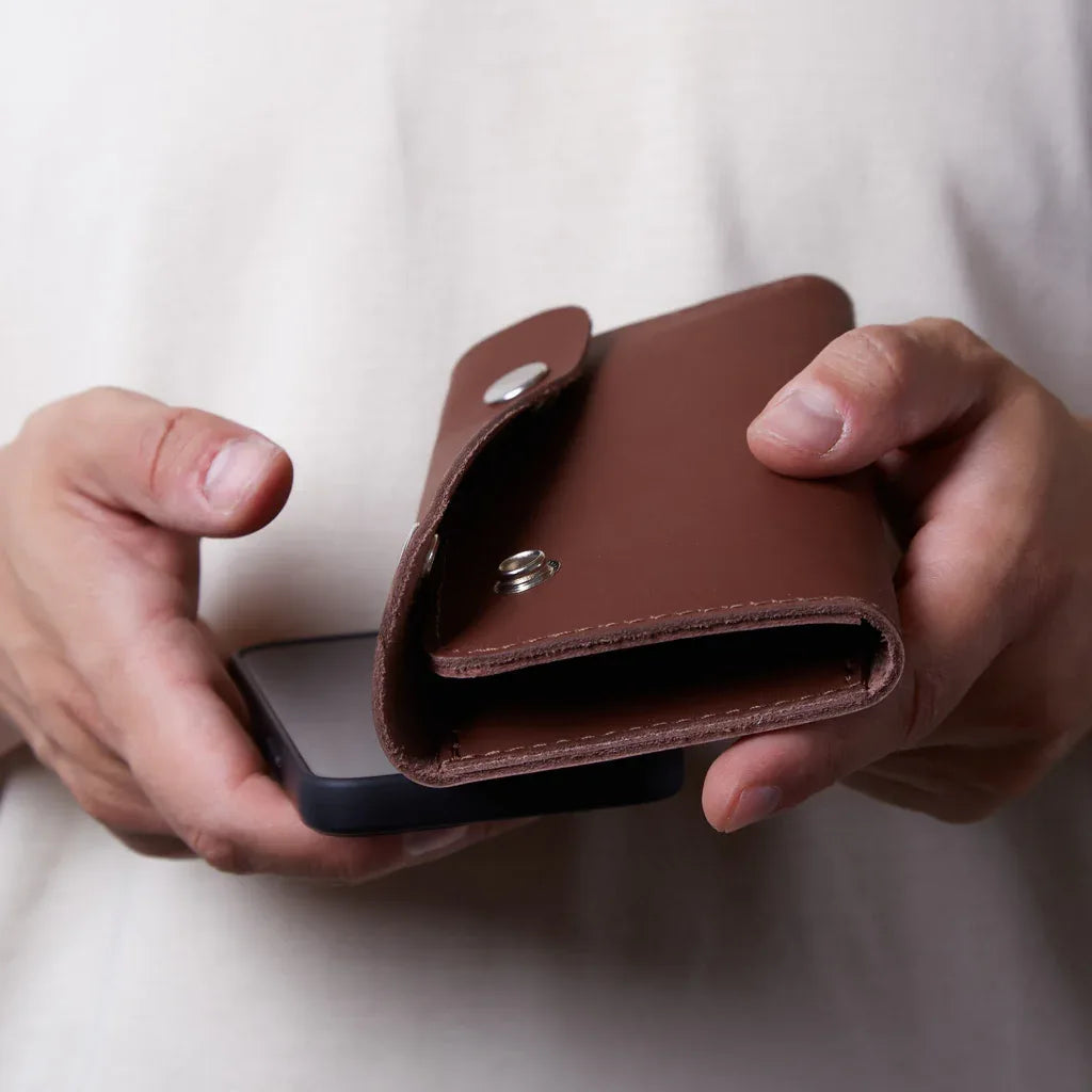 Деталь коричневої натуральної шкіри органайзера Roll Master, акуратні шви та фірмовий стиль INCARNE